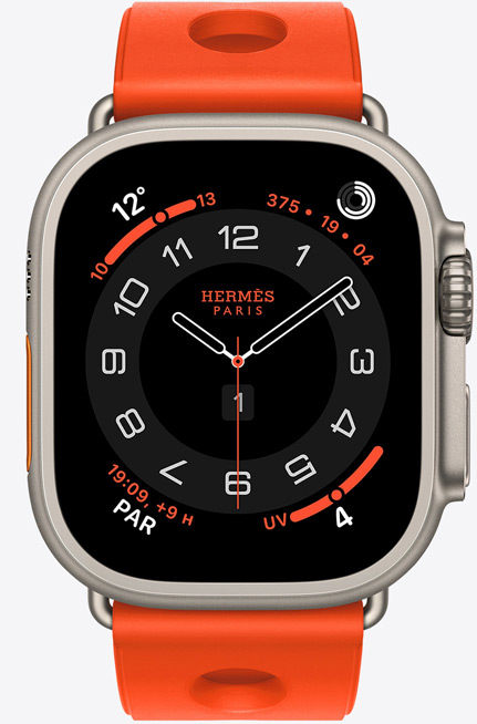 Apple Watch Hermès Ultra 3, cadran analogique Circulaire, (aiguilles des heures, des minutes et des secondes, complications : Météo, anneaux Activité, heure de Paris et Indice UV), boîtier en titane, finition naturelle, côté droit, Digital Crown, bouton latéral en saillie, associée au bracelet Scub’H Diving, orange néon (orange vif), caoutchouc moulé, découpes circulaires centrées