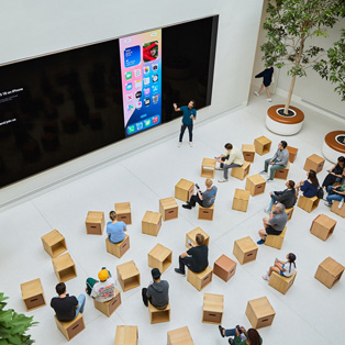 Bird's-eye view of a business training session at an Apple Store.