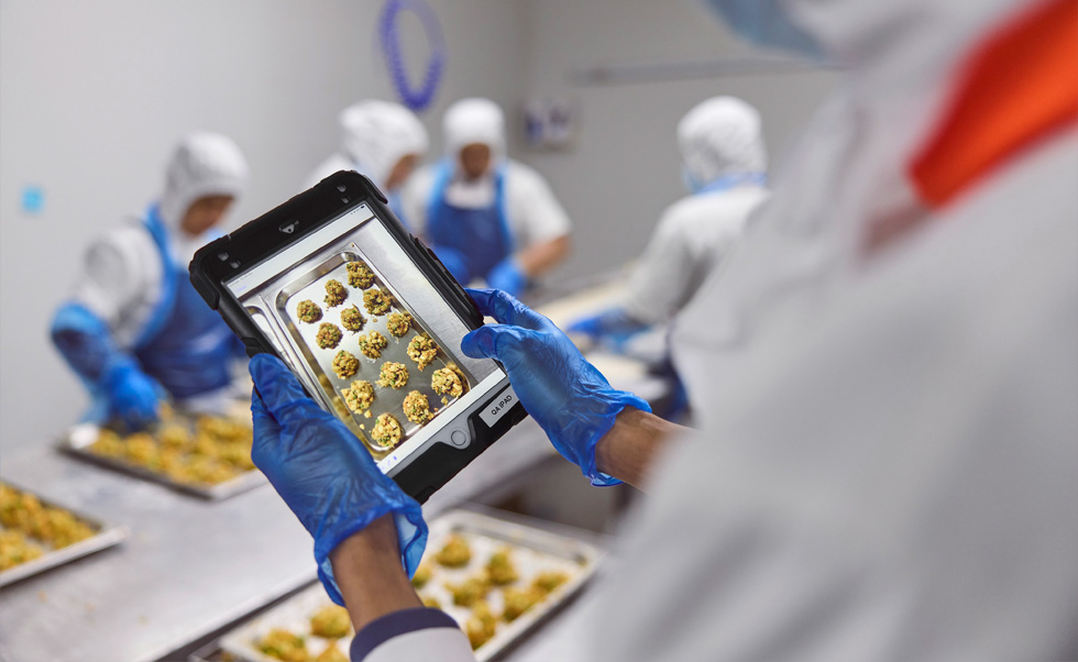 Bir çalışan iPad’i kullanarak kalite kontrolü yapıyor.