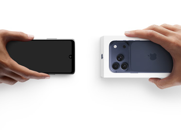 Hands exchanging phones, Android on the left without a box, on the right is a new iPhone 17 Pro  in box