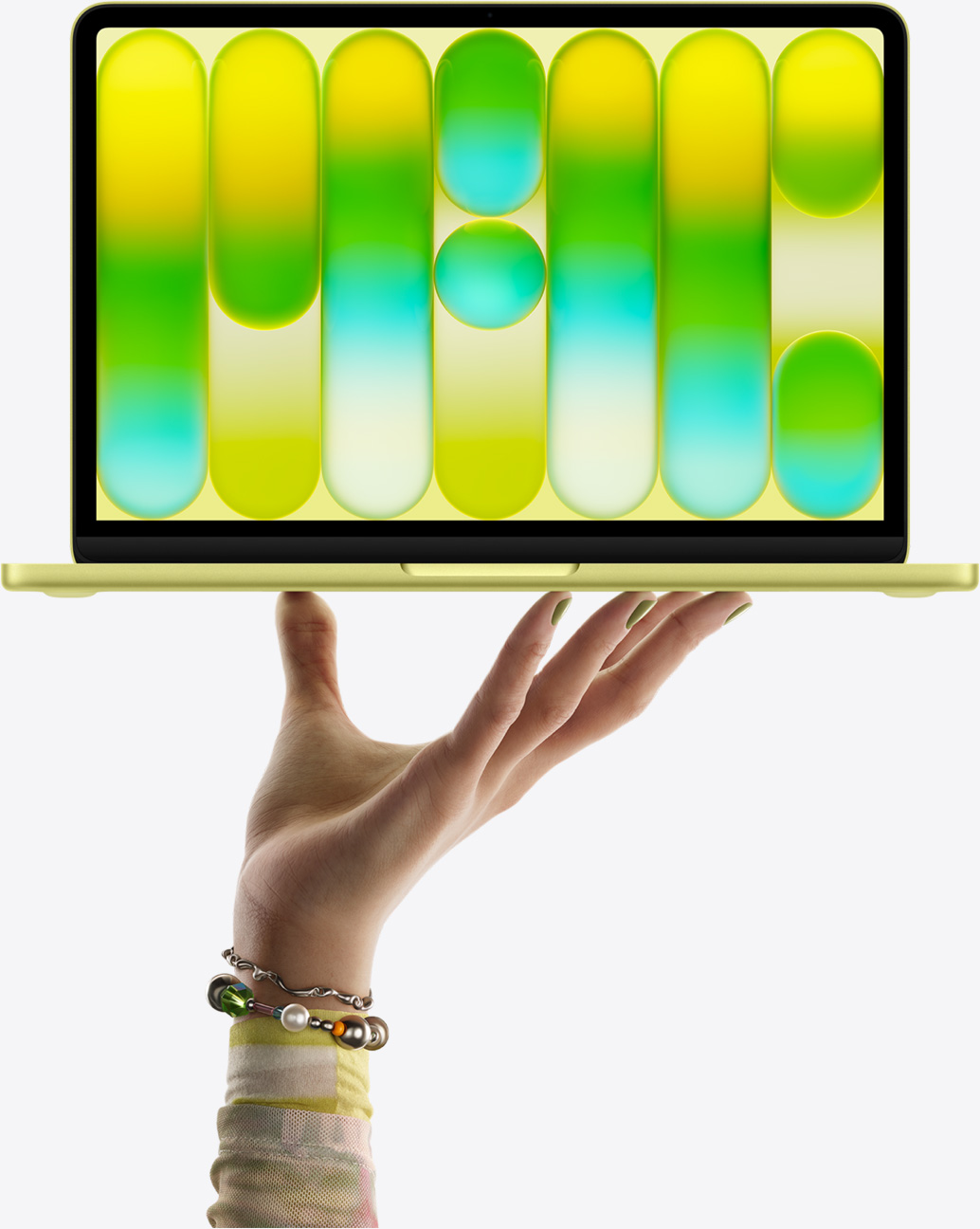 MacBook Neo in citrus color, balanced on fingertips of open hand, screen displaying colorful abstract pattern